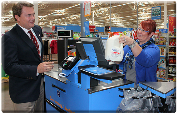 Commissioner Comer purchases a gallon of Udderly Kentucky milk